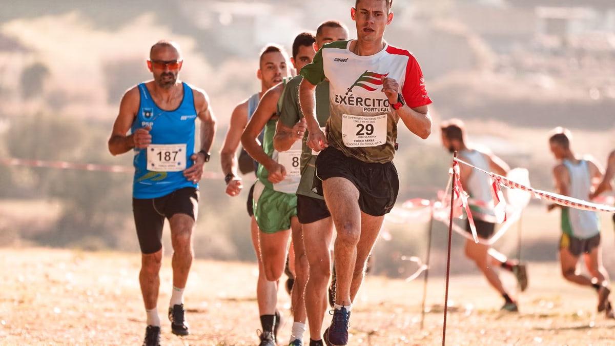Athletes running in a competitive race on a sunny day, showcasing endurance and teamwork.